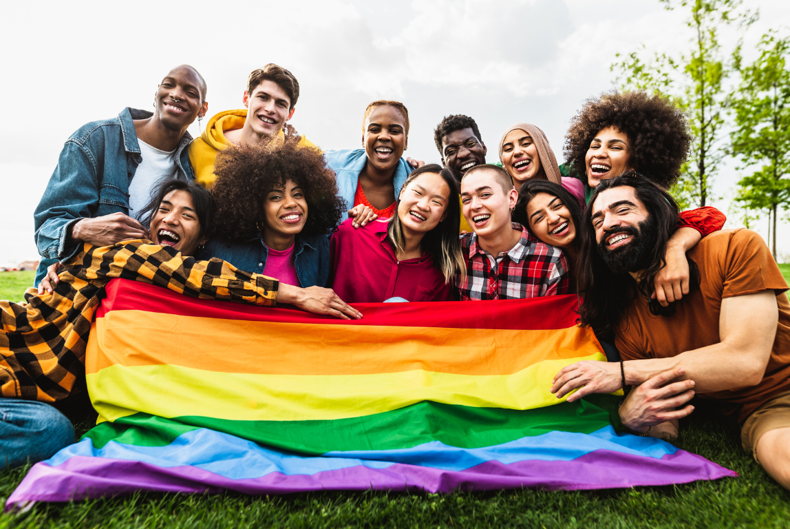 Happy diverse young friends celebrating the LGBTQ community's gay pride festival.