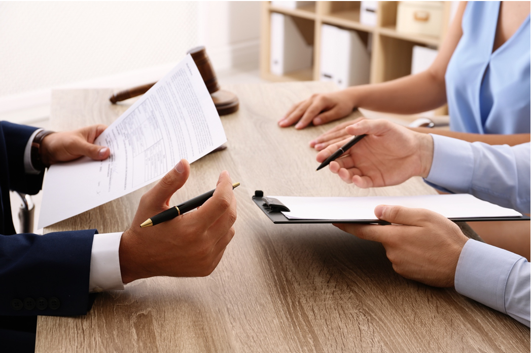 Close up of hands at a table with documents