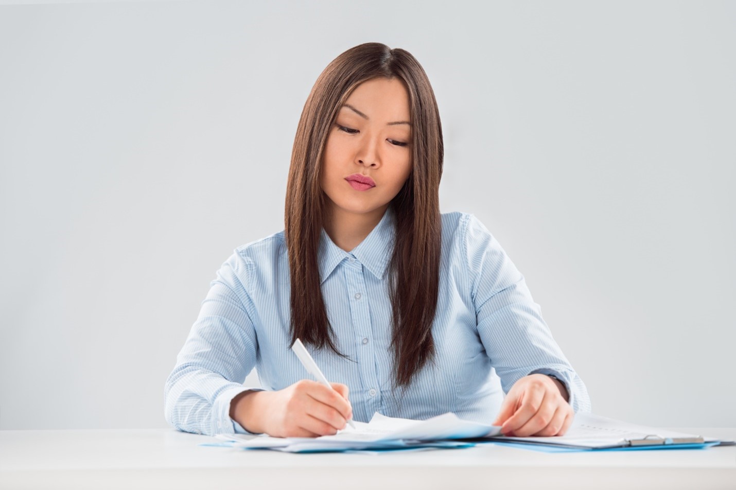 Young single woman filling out paperwork